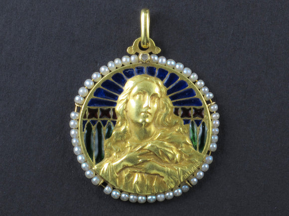 An Art Nouveau yellow gold, plique a jour enamel, and natural pearls Virgin Mary pendant.