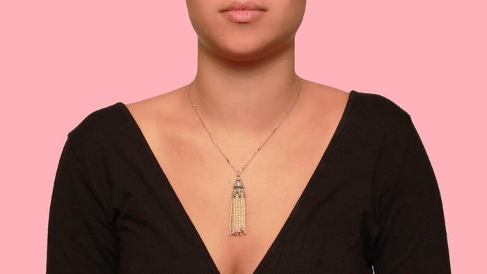 An Art Déco platinum, diamonds, sapphire and natural pearls pendant