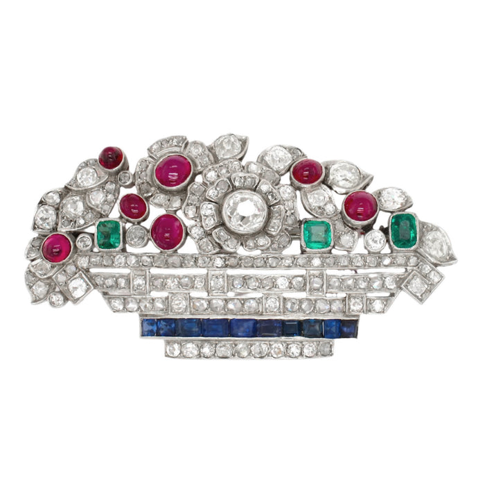 Art Déco platinum diamond, ruby emerald and sapphire basket brooch. France, 1925 c.a.
