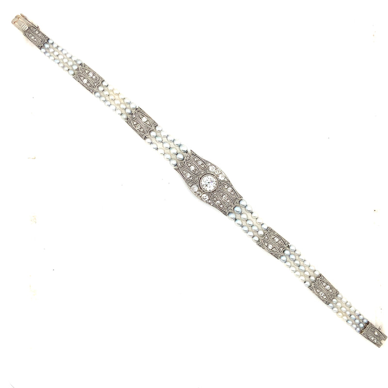 An Edwardian platinum, diamond and natural pearls bracelet