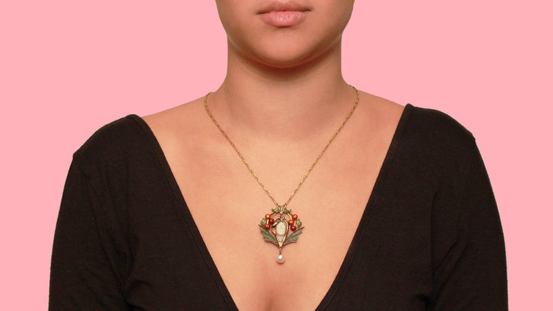 A very rare Art Nouveau gold, silver, diamond and plique à jour enamel pendant with a natural pearl.