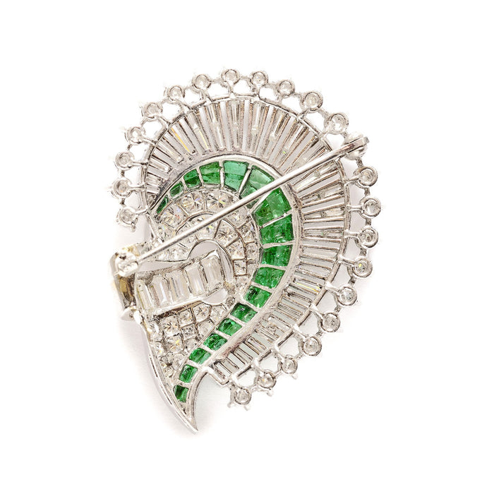 An Art Déco platinum, diamond and emerald brooch. 1925 circa