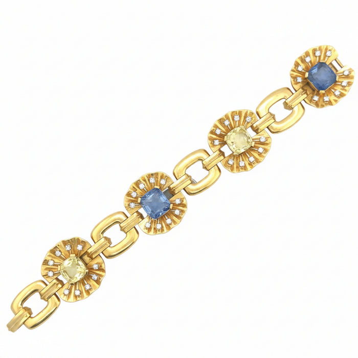 A yellow gold, diamond and yellow/blue sapphire bracelet. Period 1950 circa