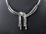 A platinum and diamond necklace, in the shape of a knot. 1950