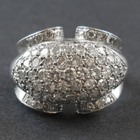 An Art Déco platinum and diamond ring centering a natural grey pearl