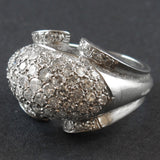 An Art Déco platinum and diamond ring centering a natural grey pearl
