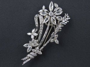 An Art Déco platinum and diamond brooch in the shape of a flower branch. Kutchinsky, London 1830 circa