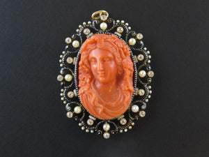 A XIX Century gold, diamond and pearl enamelled pendent centering a coral cameo.