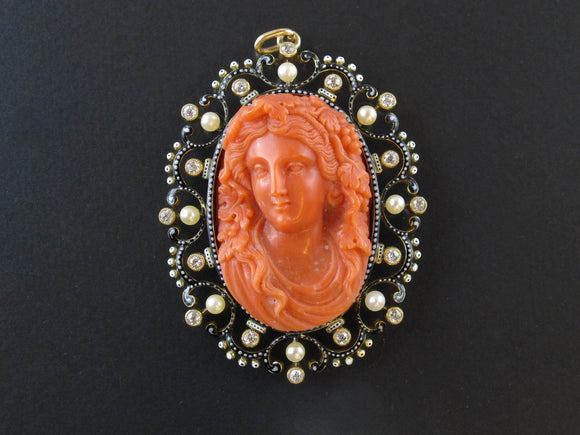 A XIX Century gold, diamond and pearl enamelled pendent centering a coral cameo.