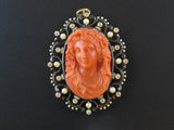 A XIX Century gold, diamond and pearl enamelled pendent centering a coral cameo.