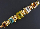 A very rare retro articulated bracelet with yellow and cognac citrine, aquamarine and a morganite. USA, 1940. 