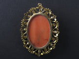 A XIX Century gold, diamond and pearl enamelled pendent centering a coral cameo.