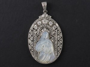 An Art Déco platinum, diamonds and mother of pearl Virgin Mary pendant.