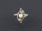 An Art Déco platinum, old cut diamond and natural perl ring