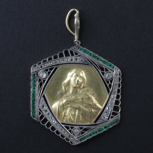 An Art Déco platinum, diamonds, emerald and yellow gold Virgin Mary pendant.