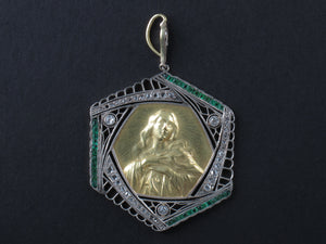 An Art Déco platinum, diamonds, emerald and yellow gold Virgin Mary pendant.