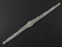 An Edwardian platinum, diamond and natural pearls bracelet