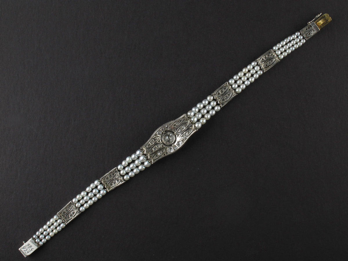 An Edwardian platinum, diamond and natural pearls bracelet