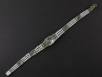 An Edwardian platinum, diamond and natural pearls bracelet