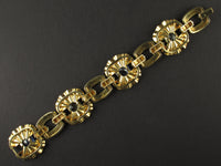 A yellow gold, diamond and yellow/blue sapphire bracelet. Period 1950 circa