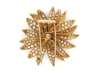 A yellow gold diamond and emerald Marguerite/Daisy Brooch. Van Cleef et Arpels, 1950 c