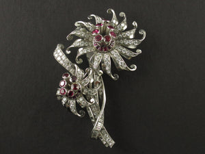 A platinum diamond and ruby brooch depicting two flowers. 1940.