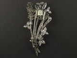 An Art Déco platinum and diamond brooch in the shape of a flower branch. Kutchinsky, London 1830 circa