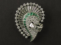 An Art Déco platinum, diamond and emerald brooch. 1925 circa