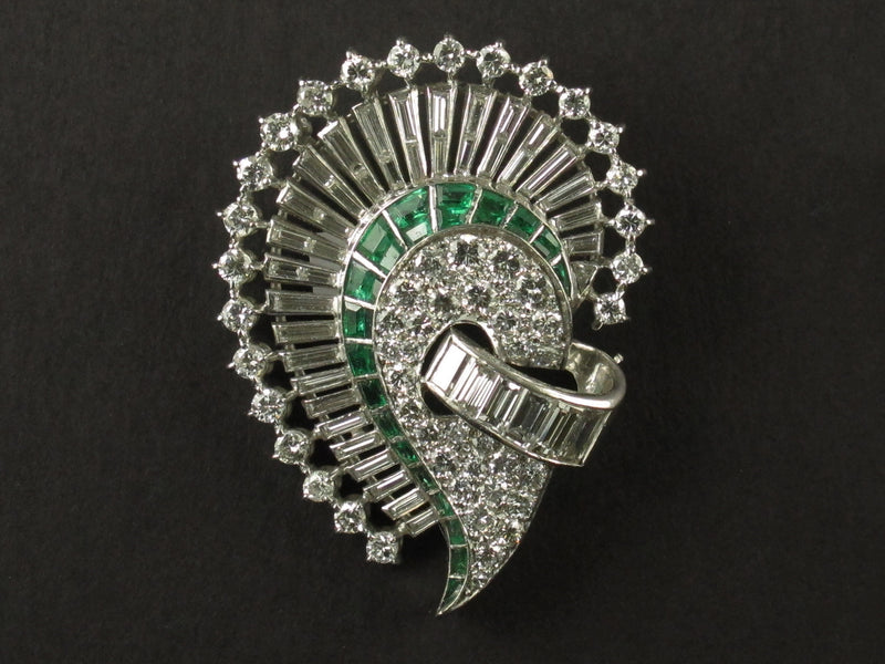 An Art Déco platinum, diamond and emerald brooch. 1925 circa