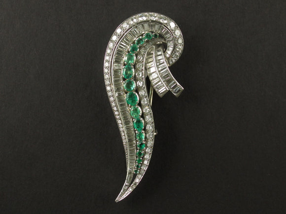 An Art Déco platinum, diamond and emerald brooch. 1935 circa