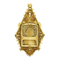 An Art Déco platinum, yellow gold, diamonds and bone Virgin Mary pendant.