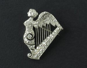 An Art Déco platinum and diamond brooch in the shape of a harp. 1920 circa