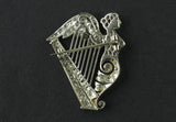 An Art Déco platinum and diamond brooch in the shape of a harp. 1920 circa
