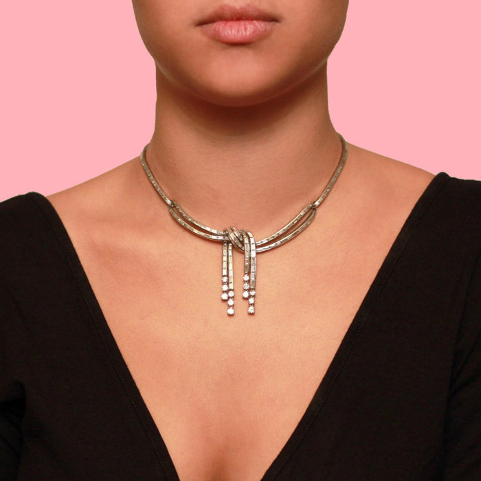 A platinum and diamond necklace, in the shape of a knot. 1950