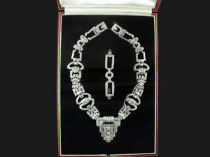 An Art Déco platinum and diamond necklace, transformable in two bracelets and one brooch. In original fitted box