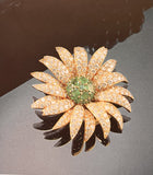 A yellow gold diamond and emerald Marguerite/Daisy Brooch. Van Cleef et Arpels, 1950 c