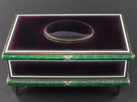 A silver-gilt singing bird automation box with guilloche in translucent violet and green enamel , the oval cover enamelled opening to reveal a singing feathered bird. Swiss 1960