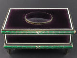 A silver-gilt singing bird automation box with guilloche in translucent violet and green enamel , the oval cover enamelled opening to reveal a singing feathered bird. Swiss 1960