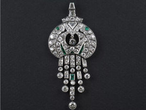 An Art Déco platinum diamond and emerald pendant. 1925 c.a.