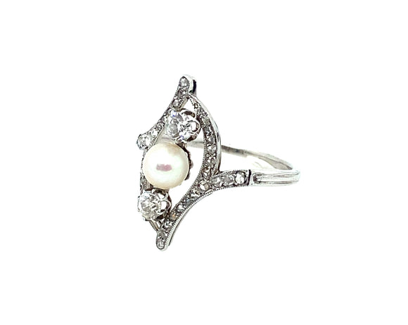 An Art Déco platinum, old cut diamond and natural perl ring