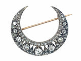 Antique silver topped, yellow gold and diamond crescent brooch