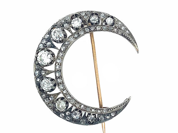 Antique silver topped, yellow gold and diamond crescent brooch